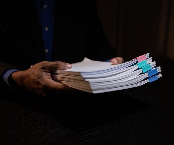 a businessman works overtime is his accounting firm's office until late at night, an entrepreneur remains at his export company because he has a lot of customer documents to check