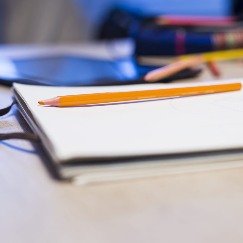 Colorful assortment of school supplies on table. Selective focus and small depth of field.
